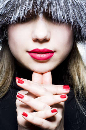 Beautiful girl with red lips in fur hatの写真素材