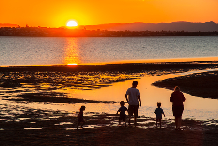 Family relaxing and playing on a beach at Wellington Point, Brisbaneの写真素材