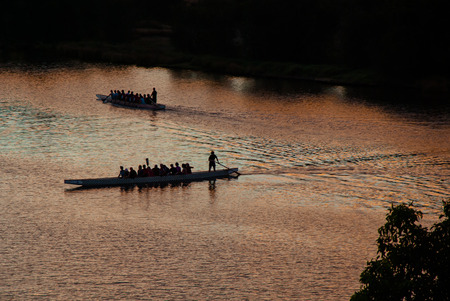 Two rowing boats at sunset make their way down Margaret River in Perth, WAの写真素材