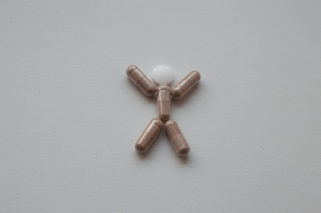Pills man on grey backgroundの写真素材