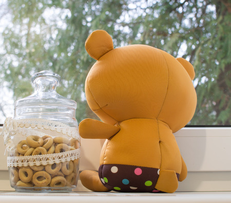 Lovely bear toy near windowの写真素材