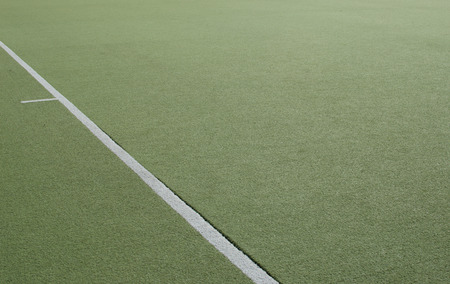 Green grass of football field closeup white lineの写真素材