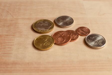Coins on wooden desk. New Belarus coins. Front sides. Natural light and blur foregroundの写真素材