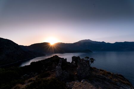 Sunrise over sea and mountains. Rocks and water senery. Turkey landscapeの写真素材