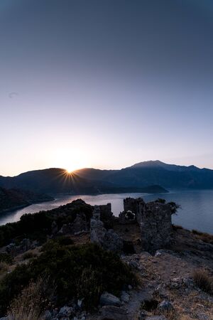 Sunrise over sea and mountains. Rocks and water senery. Turkey landscapeの写真素材