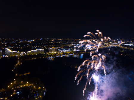 Firework shoot from drone. River and night city view. Musical festival endの写真素材