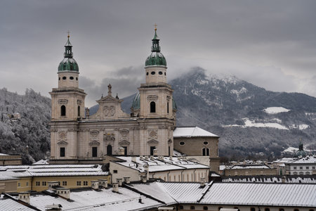 Cloudy Salzburg rooftop view, historical architecture, mountains, Austria winter.の写真素材
