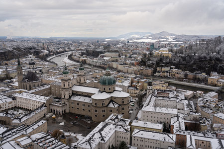 Cloudy Salzburg rooftop view, historical architecture, mountains, Austria winter.の写真素材