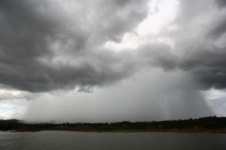 Heavy raining on the lake shoreの写真素材