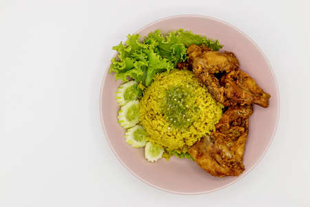 Muslim yellow rice with chicken on white backgroundの写真素材