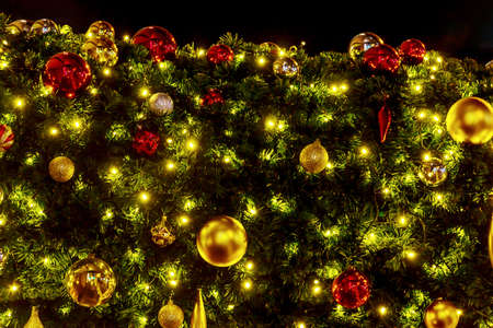 Christmas tree decorated red gold balls and Christmas accessories with light point shining bright beautifulの写真素材