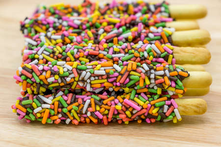 Chocolate biscuit stick with colorful sugarの写真素材