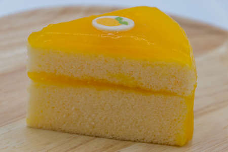 Orange cake on wood plate