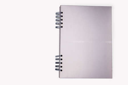 Silver notebook on white backgroundの写真素材