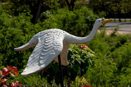White bird stucco is flying in gardenの写真素材