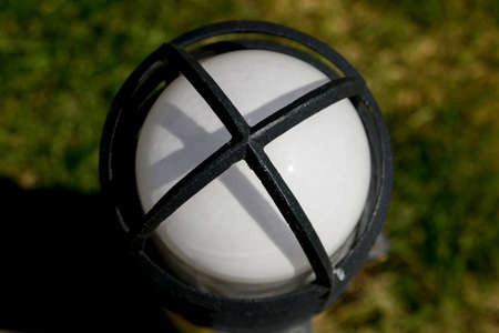 White lamp with black iron in the gardenの写真素材