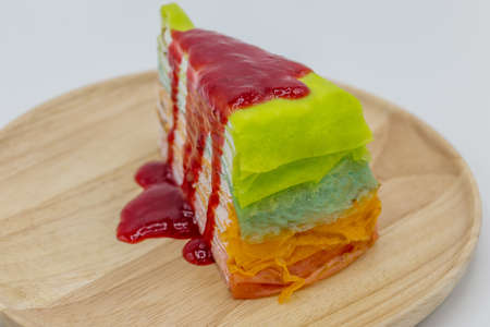 Rainbow crepe cake on wooden tray