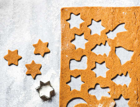 Prearation of traditional Christmas gingerbread cookieson a parchment