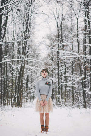 Portrait of a beautiful young woman in fairytale winter forestの写真素材