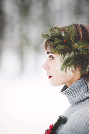 Portrait of a beautiful young woman in winter forestの写真素材