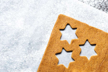Prearation of traditional Christmas gingerbread cookies on a cooking paperの写真素材