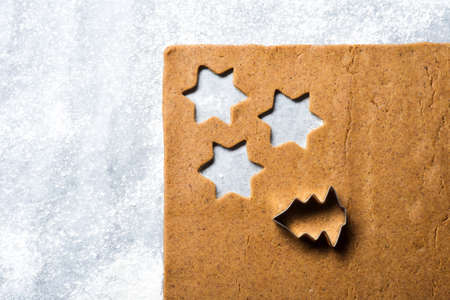 Prearation of traditional Christmas gingerbread cookies on a cooking paperの写真素材