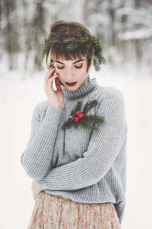 Beautiful young woman in winter forestの写真素材