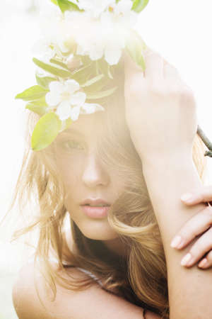 Portrait of beautiful romantic lady in apple trees blossomsの写真素材