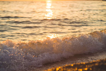 Sea waves and ripples at sunset backgroundの写真素材