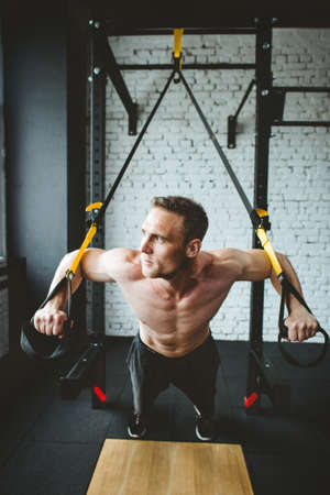 Man in sportswear exercising at gymの写真素材