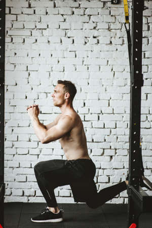 Man in sportswear exercising at gymの写真素材