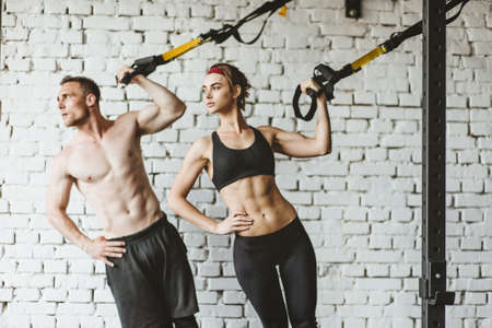 Young sporty couple workout in gym