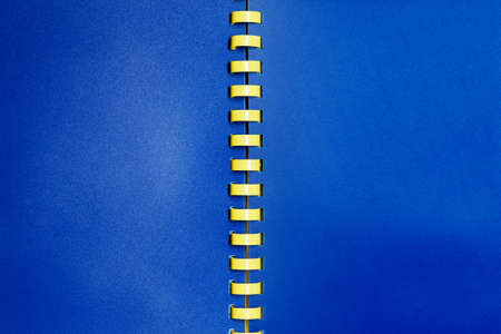 Blue empty notebook with yellow spiralの写真素材