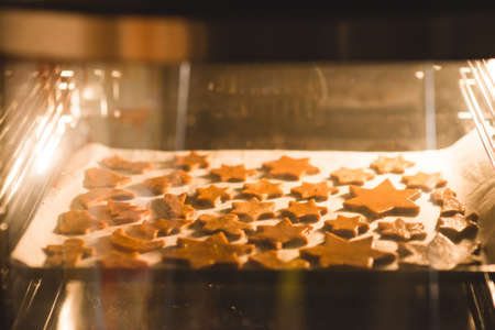 Christmas cookies in the ovenの写真素材