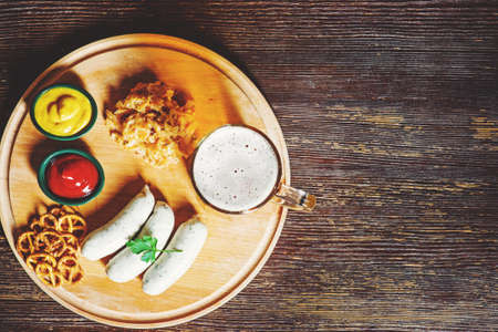 Bavarian sausages with pretzel, sweet mustard and beerの写真素材