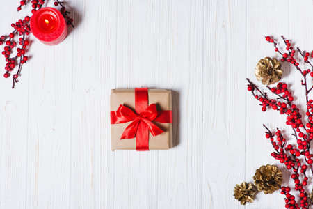 Christmas presents box with red ribbon on a wooden table background