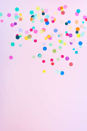 Festive party or carnival confetti on pink backgroundの写真素材