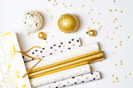 Cropped photo of Christmas wrapping paper and golden balls on white backgroundの写真素材