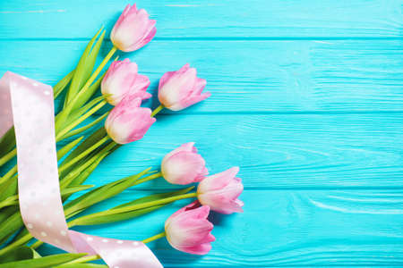 Wooden blue background and pink tulips. Holiday concept, March 8, Mother's Day.の写真素材