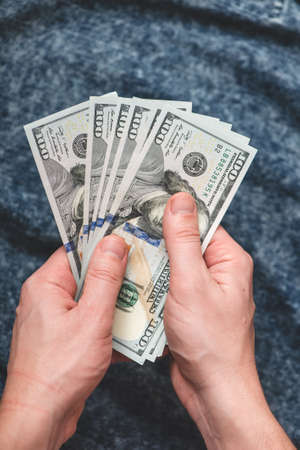 Hands holding us dollar bills. Toned pictureの写真素材