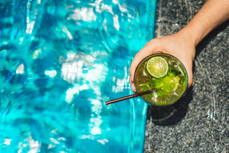 Man holding tropical mojito cocktailの写真素材