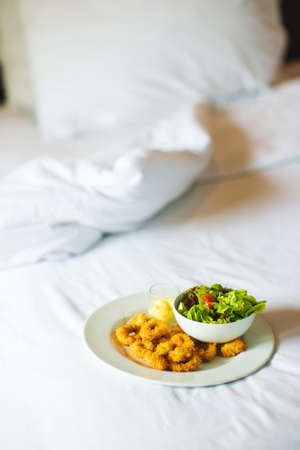 Breakfast in bed on luxury hotel. Cheat meal concept.の写真素材