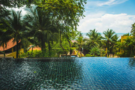 Poolside with beautiful sea view in tropical resort in Thailand.の写真素材