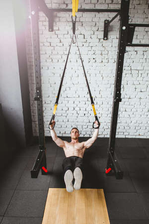 Athletic man in sportswear exercising at gymの写真素材