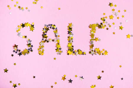 Word SALE made of many gold stars on pink background