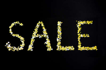 Word SALE made of many gold stars on black background. Black friday sale conceptの写真素材