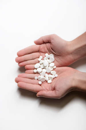 Men hands holding bunch of pills isolated on white