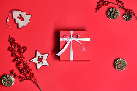 Top view of Christmas gift box with decor on red backgroundの写真素材