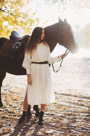 Portrait of beautiful woman standind with horseの写真素材
