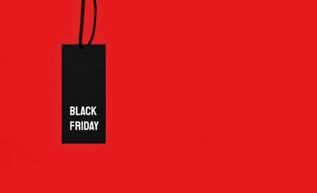 Sale tag with Black Friday inscription on red background.